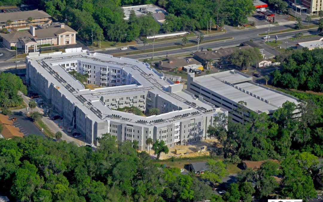Aerial View of Liv+ Gainesville Apartments With Trees Surrounding It