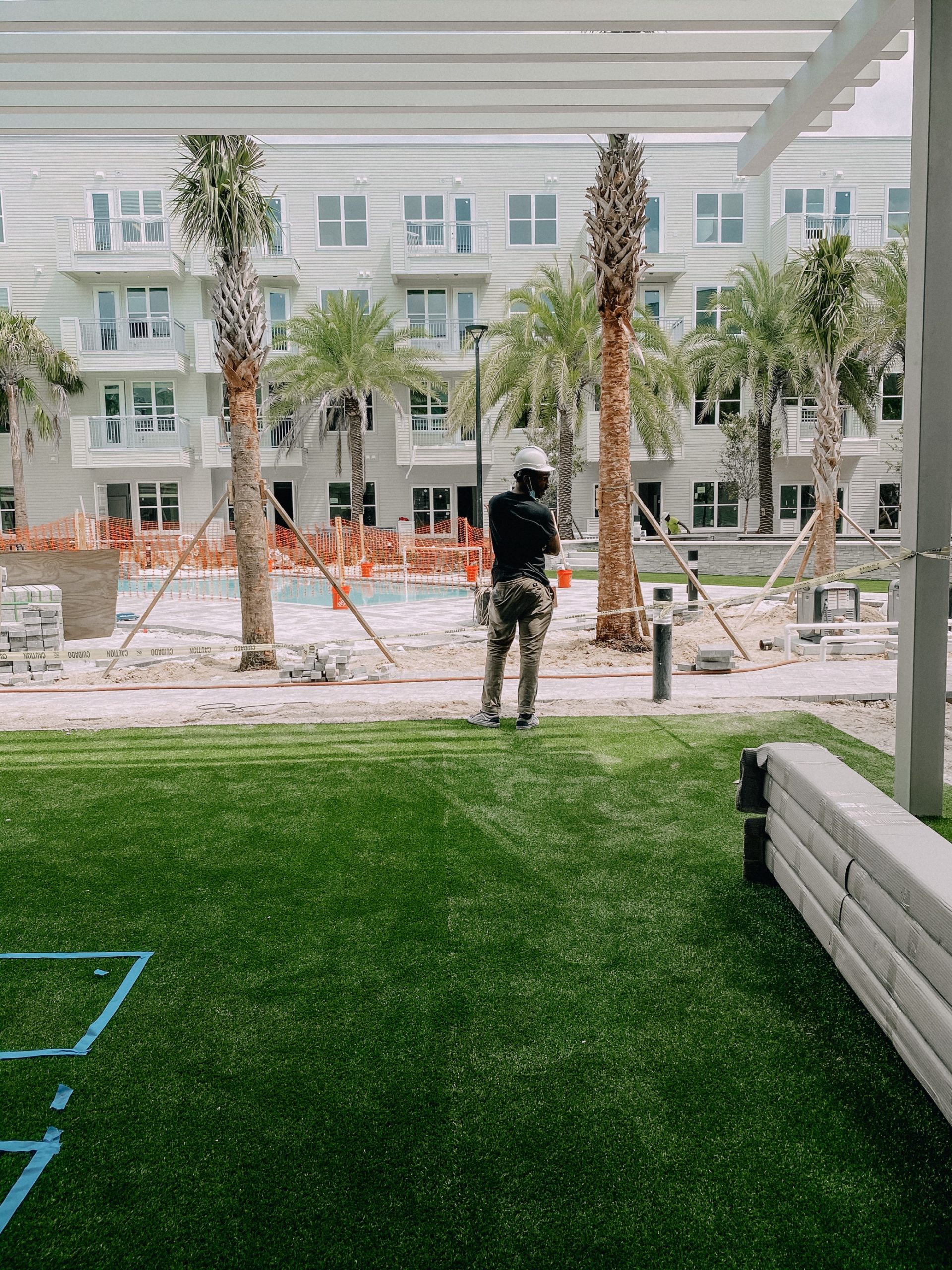 Courtyard at Liv+ Gainesville Apartments With a Construction Worker in the Background
